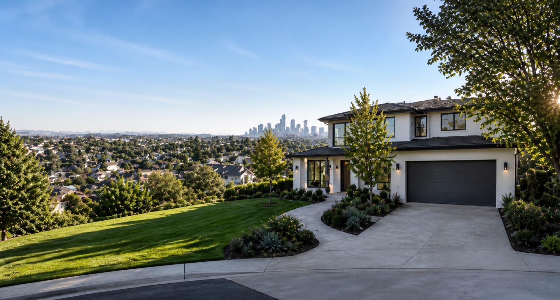 Modern hillside home overlooking a tree-lined neighborhood with a city skyline in the distance