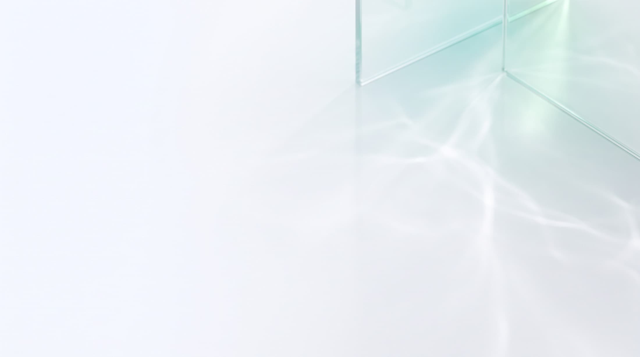 Light refracting through glass panels on a white surface